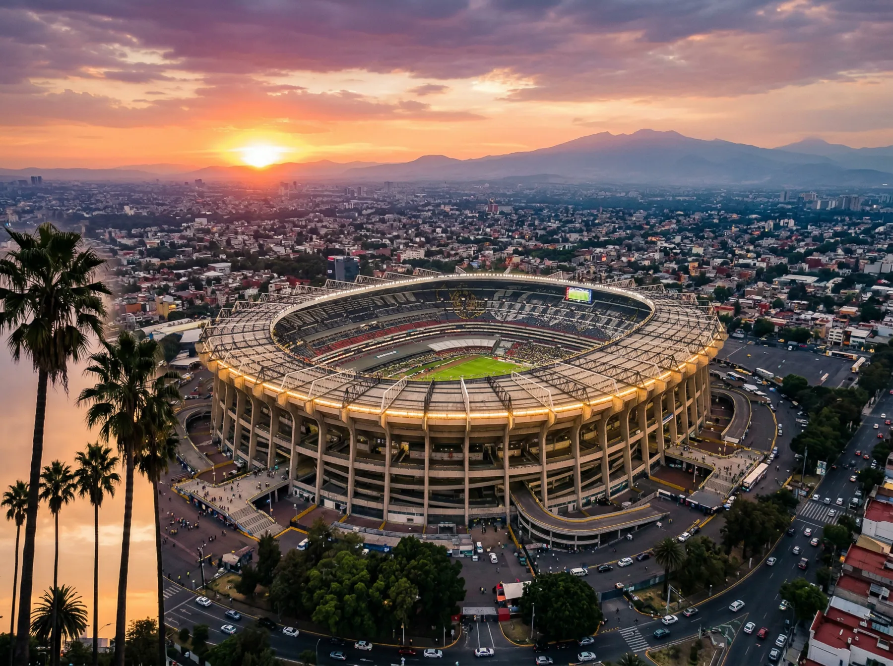Estadio Azteca in Mexico City at sunset with the stadium bowl and surrounding mountains visible